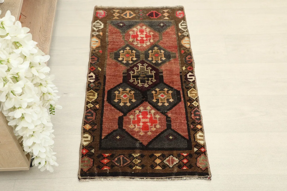 Straight overhead view showcasing the full rust field and geometric patterns of the vintage Anatolian rug.