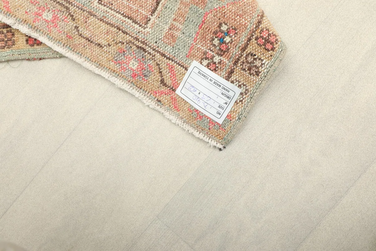 Detail of the rug's back, revealing the hand-knotted cotton foundation and the care label.