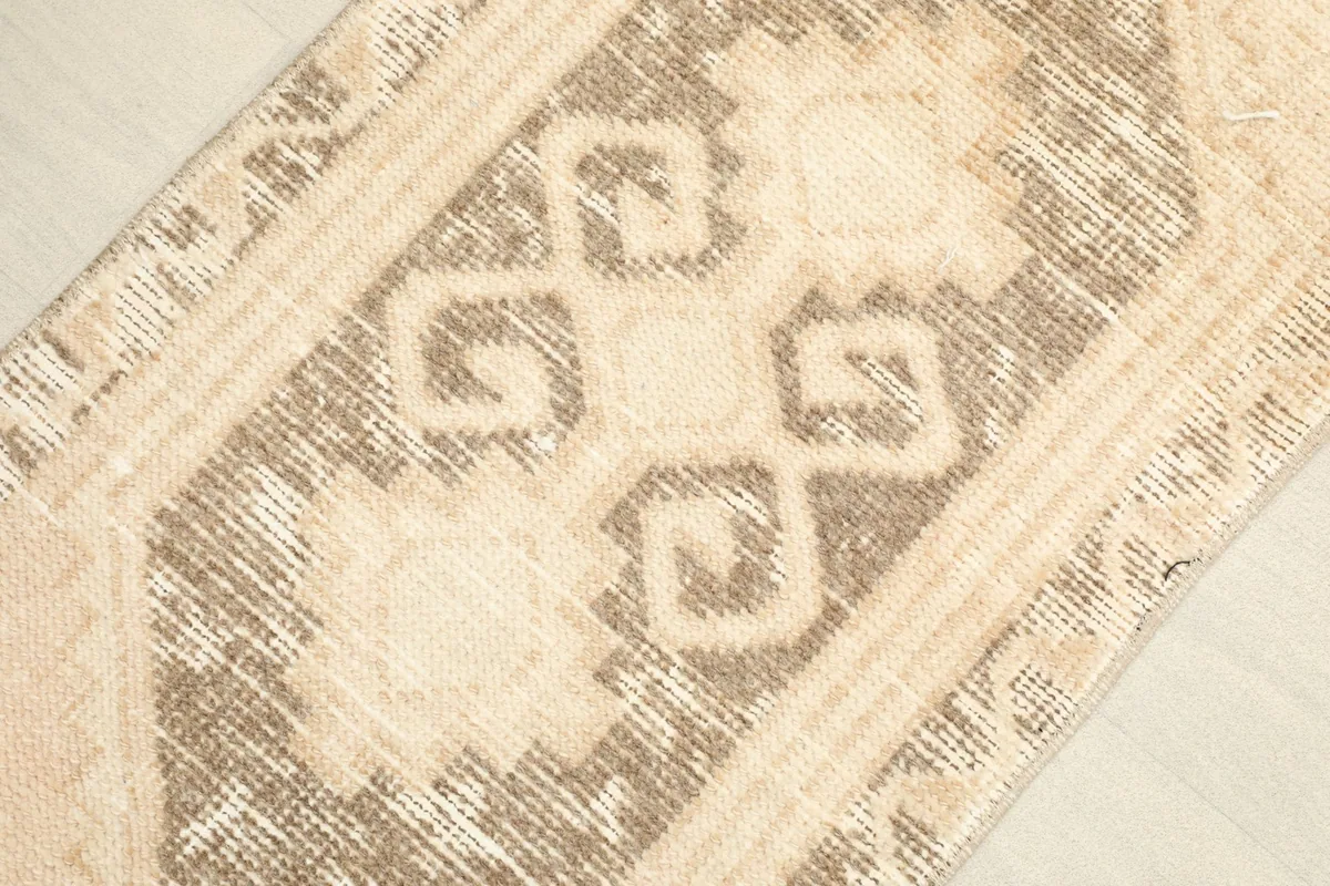 Detailed view of the central brown and tan geometric medallion and surrounding patterns.
