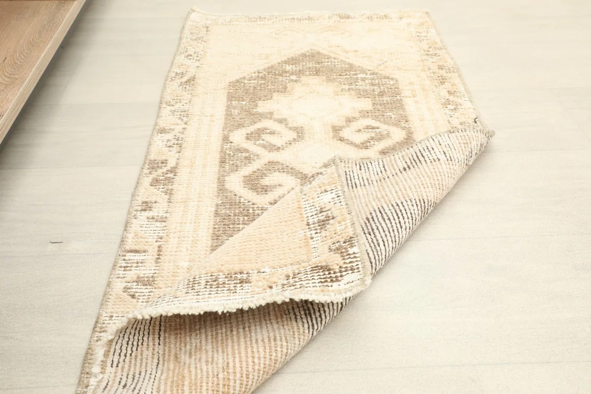 The rug partially folded, illustrating its flexibility and the texture of the back.