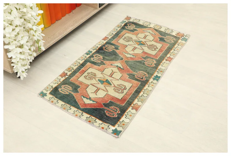 Full top view of the 1'8" x 3'5" vintage Anatolian doormat with navy, rust, and ivory geometric patterns