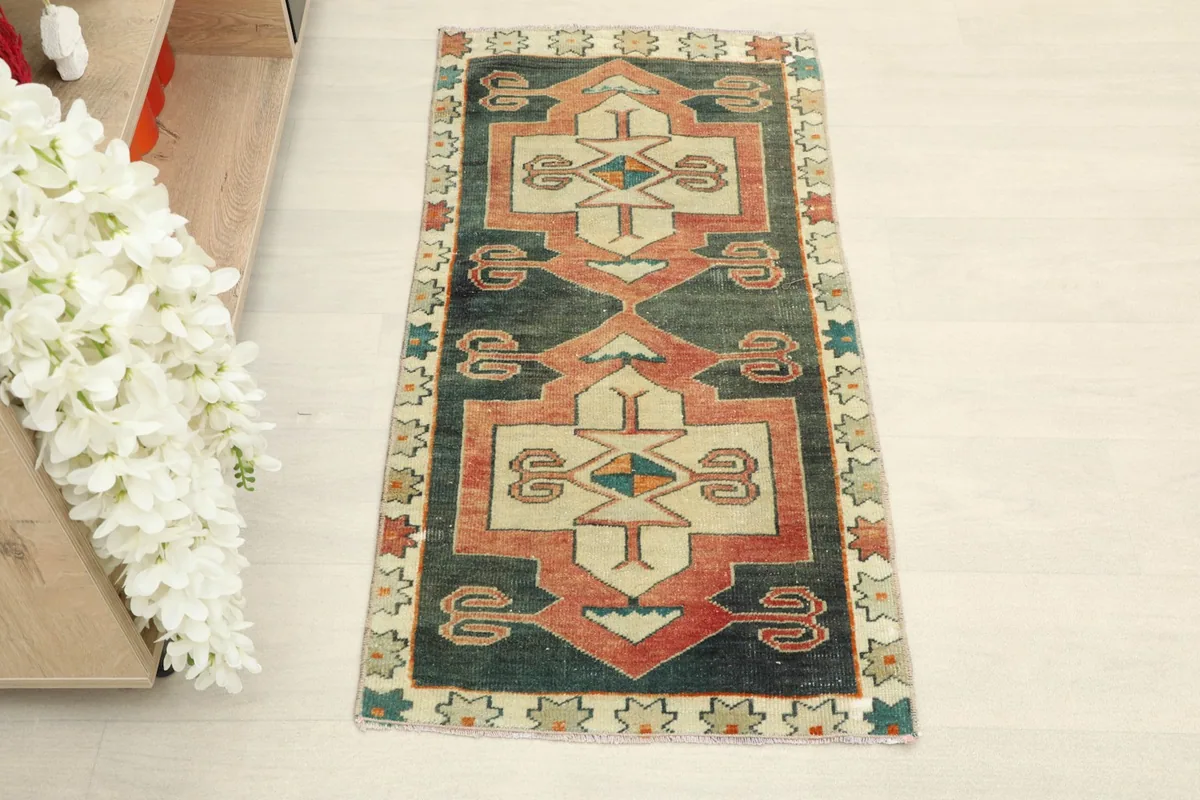 Overhead view of the hand-knotted doormat, highlighting its central geometric motifs and colors