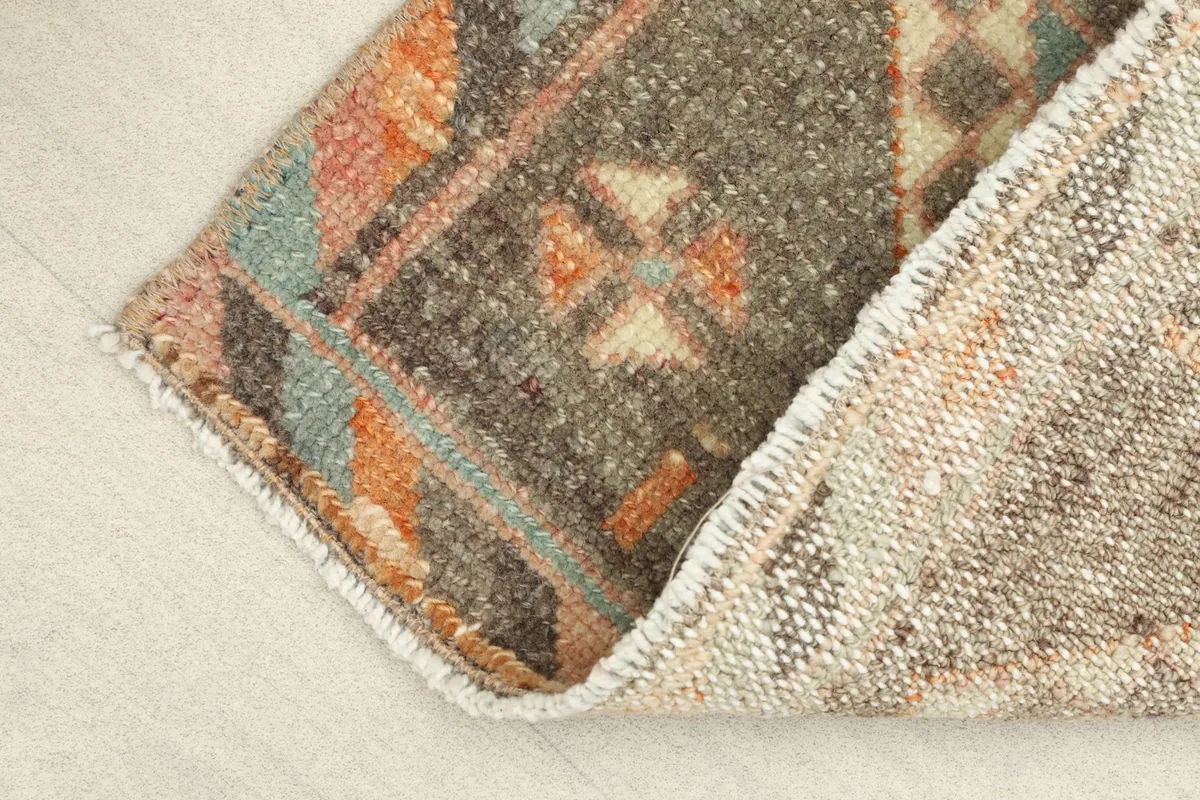 View of the rug's reverse side, revealing the hand-knotted cotton foundation and wool pile