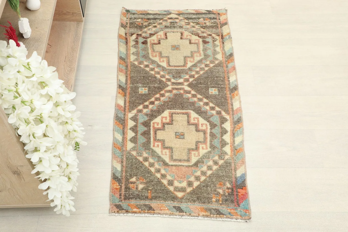 Overhead view of the vintage Anatolian doormat, showing its full design and colors