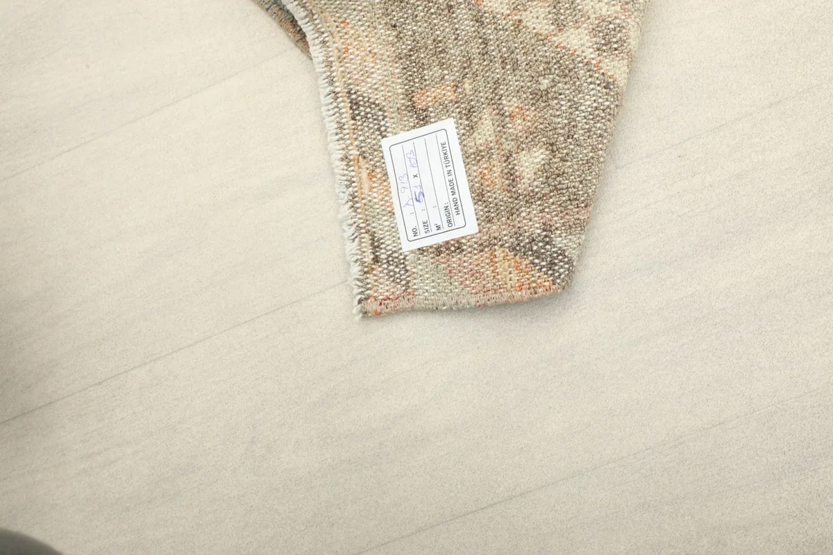 Close-up of the rug's back with a product information label visible