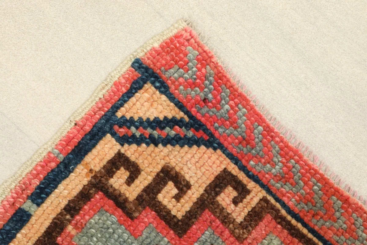 Close-up of the upper left corner showing the rose border and navy geometric elements.