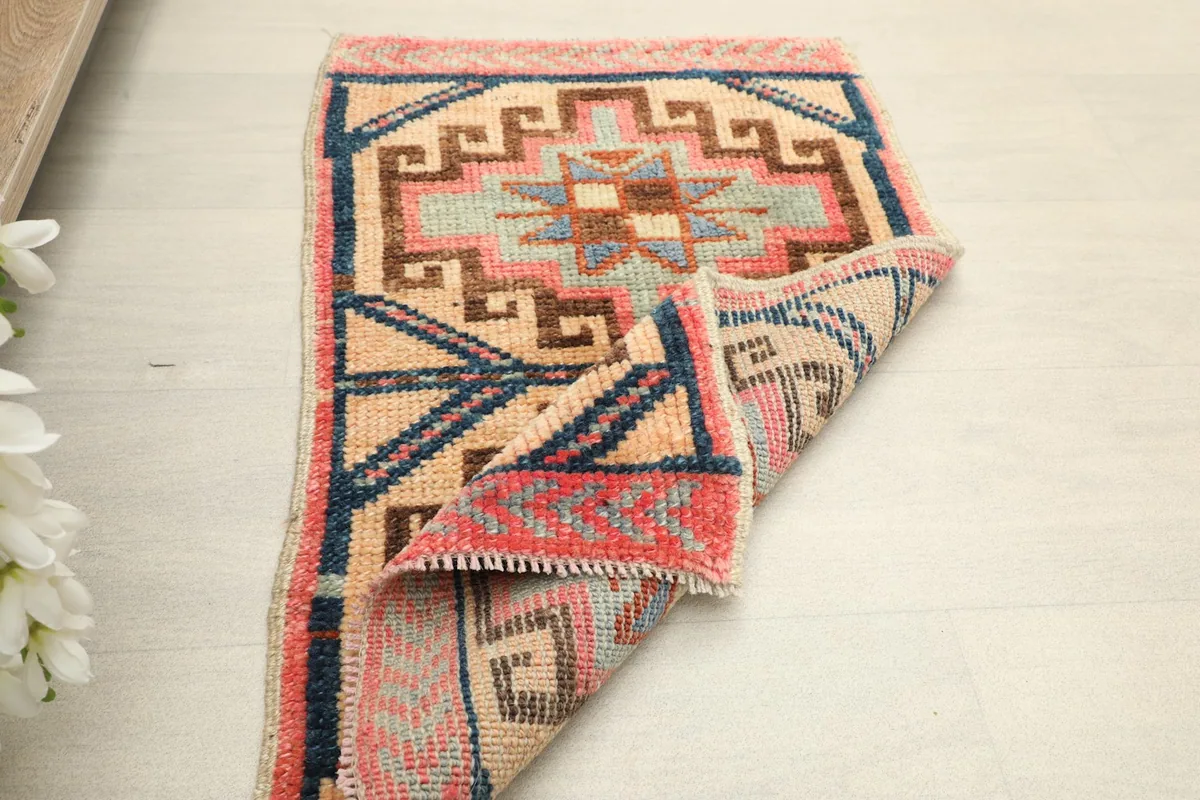 Another view of the rug partially folded, showing the texture and construction from a different angle.