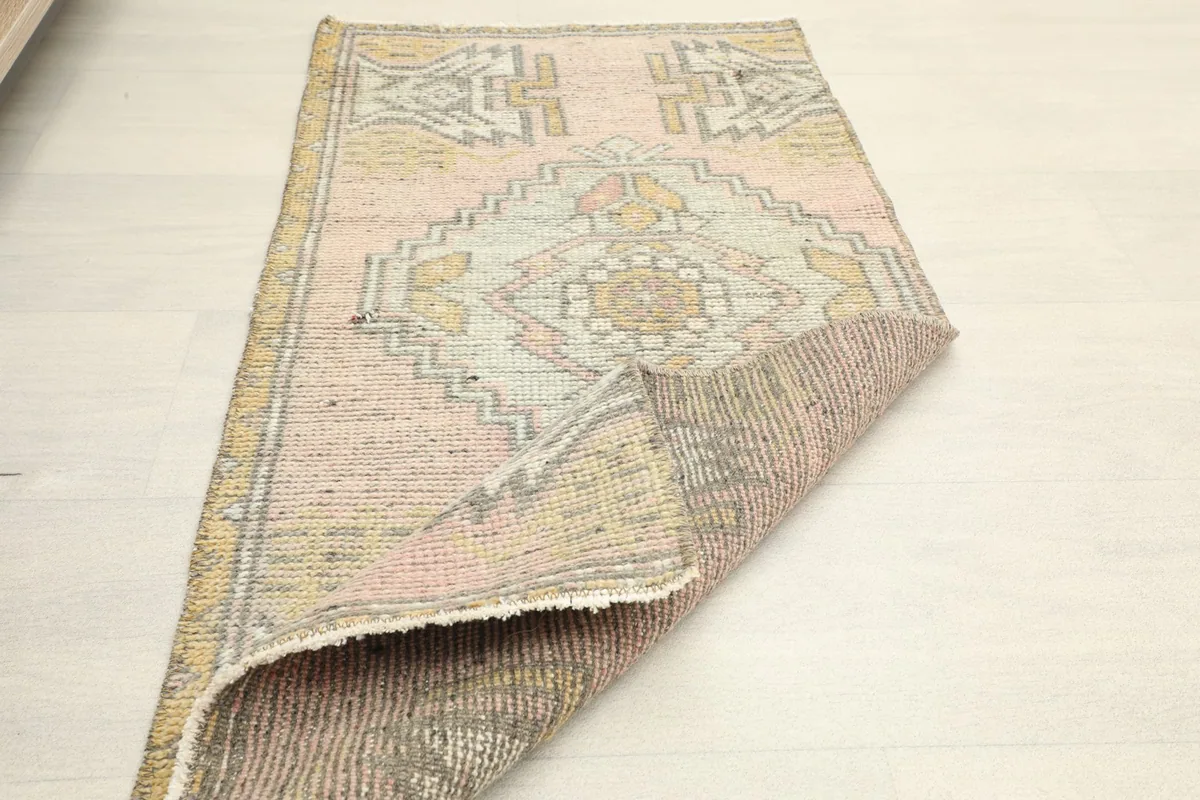Another perspective of the rug with a corner folded back, revealing the reverse side.