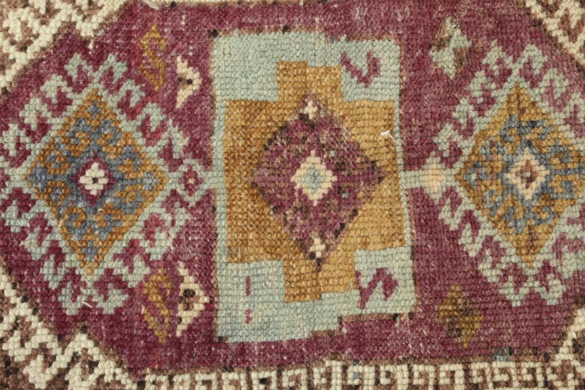Detailed shot of the wool pile, revealing the intricate weaving and color variations within the central design.