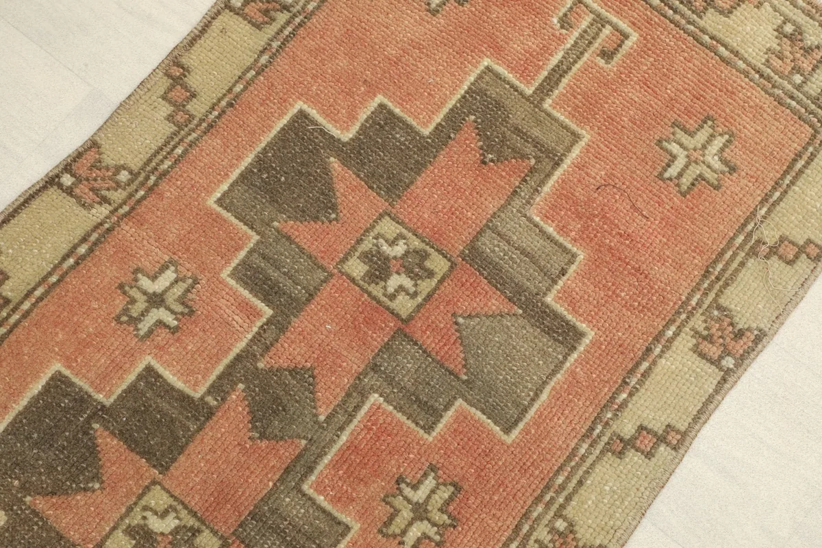 Angled view highlighting the rich rust color and the distinct geometric motifs in brown.
