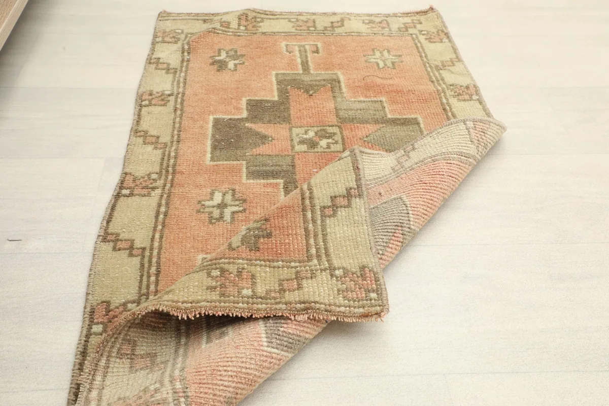 The rug partially folded, revealing the back of the hand-knotted cotton foundation.