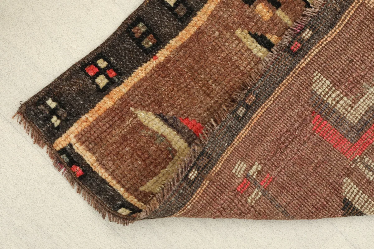 The rug folded to reveal the thickness of the wool pile and the hand-knotted construction.