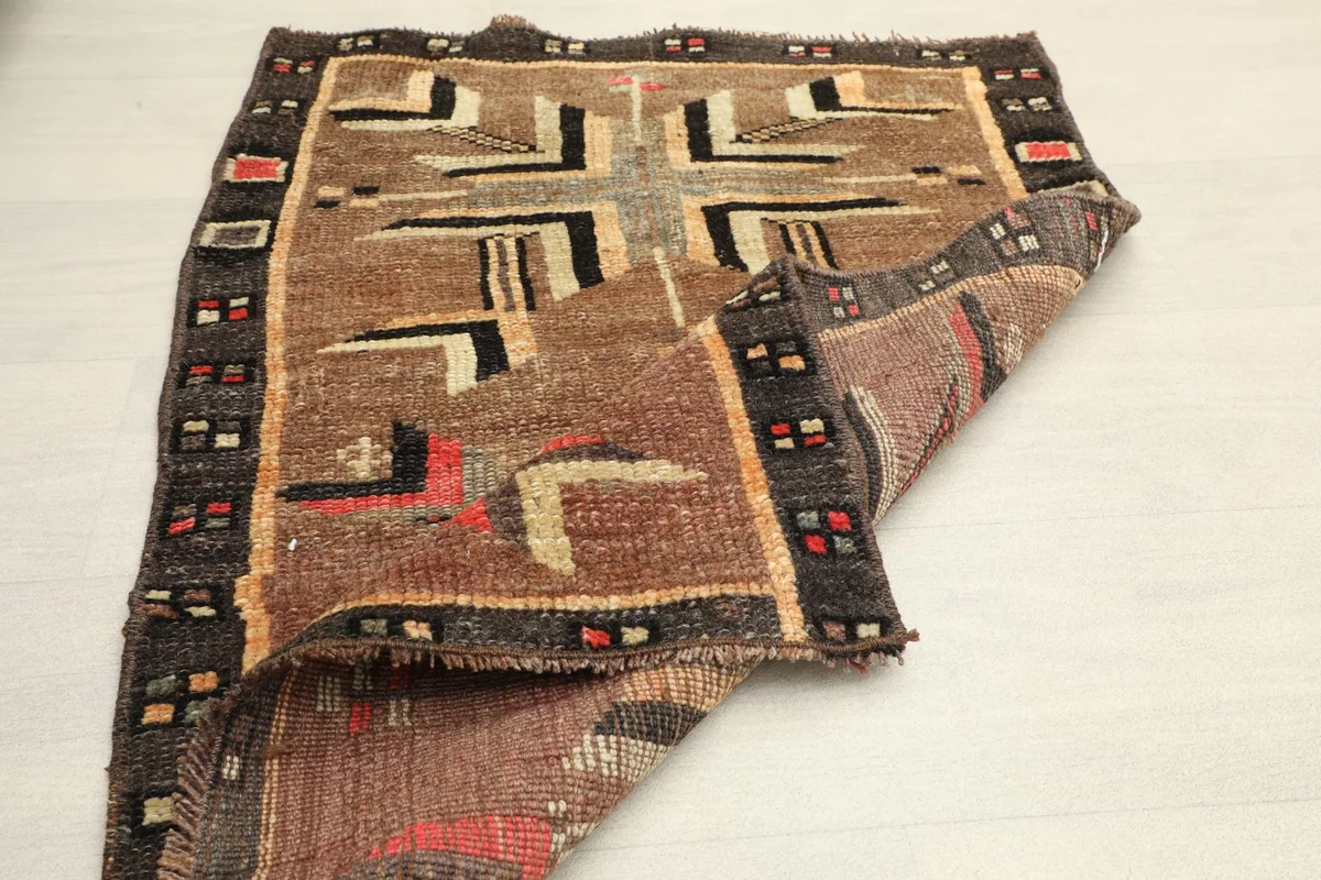 Another view of the rug partially folded, emphasizing its compact size and flexibility.