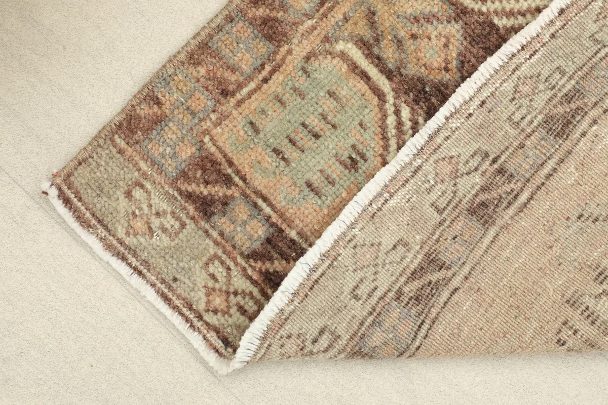 View of the rug's underside, revealing the hand-knotted cotton foundation.