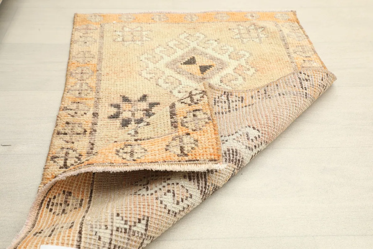 Side view of the rug with a corner gently folded back, displaying its thickness and construction.