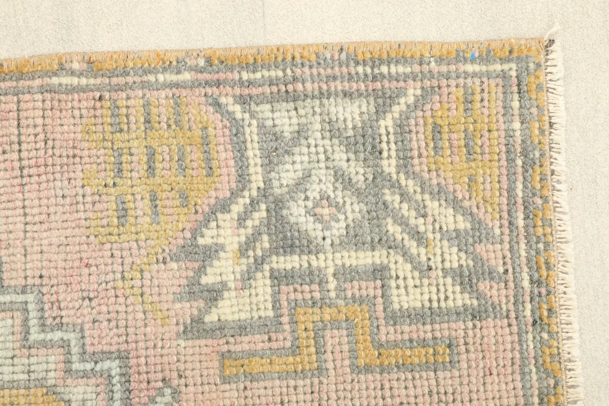 Detailed view of the side border and corner motif, revealing the hand-knotted texture.