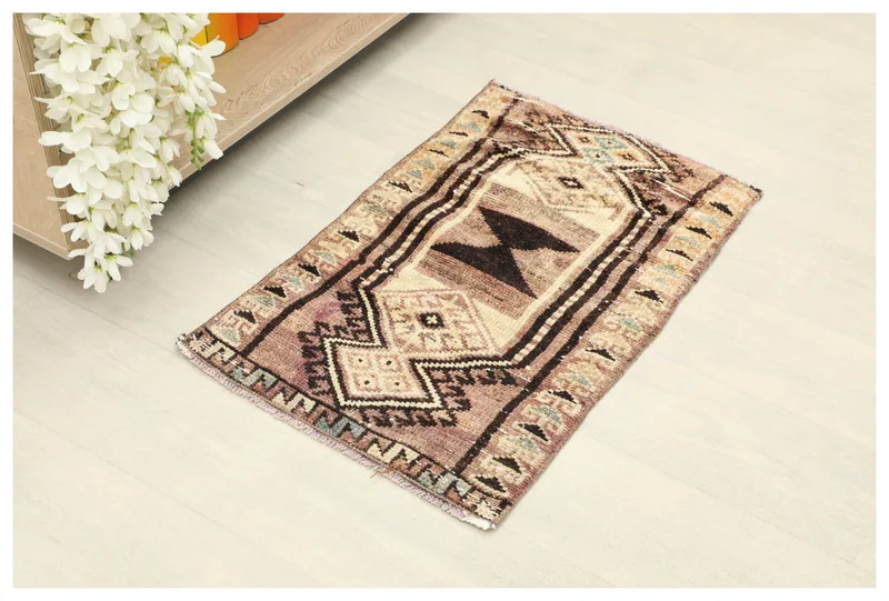 Full top view of the 1'7" x 2'5" vintage Anatolian rug with rose and brown geometric patterns