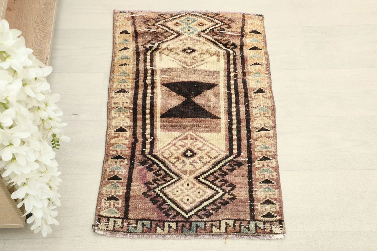 Overhead view of the small hand-knotted rug, highlighting its central geometric design