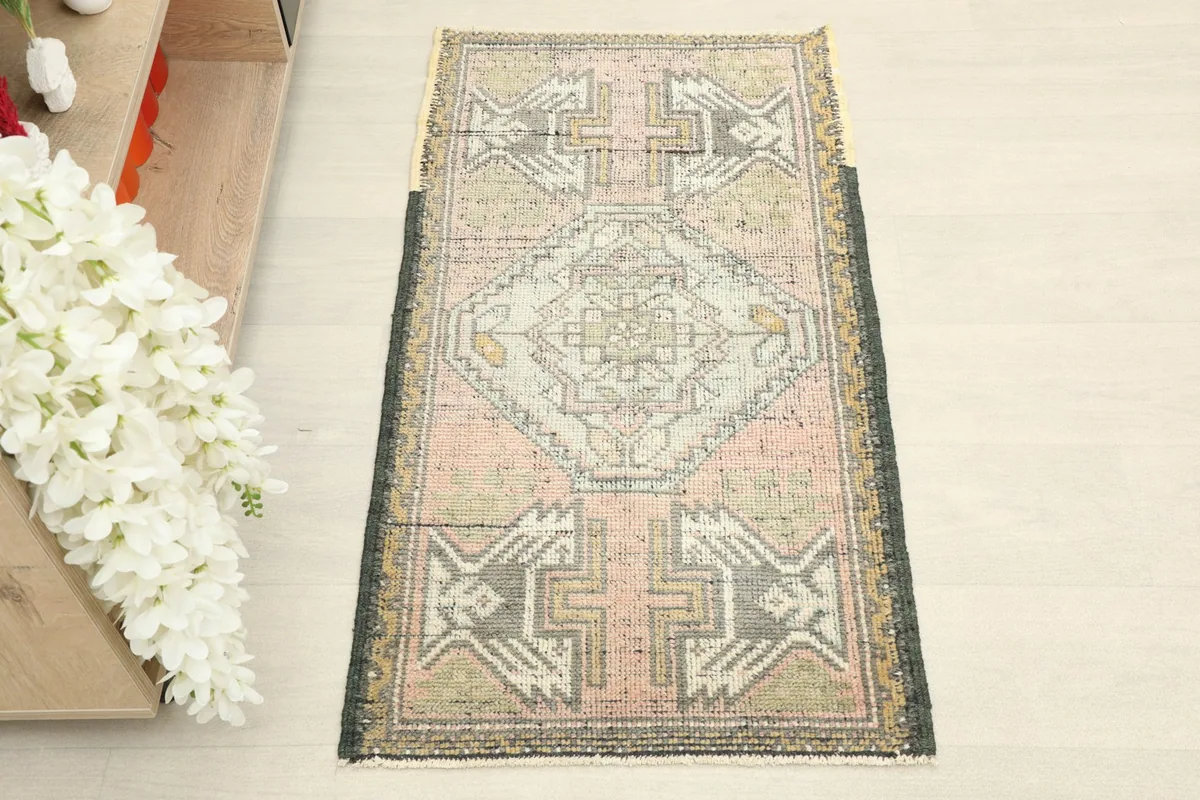 Overhead view of the hand-knotted wool rug, showcasing its central medallion and tribal motifs.