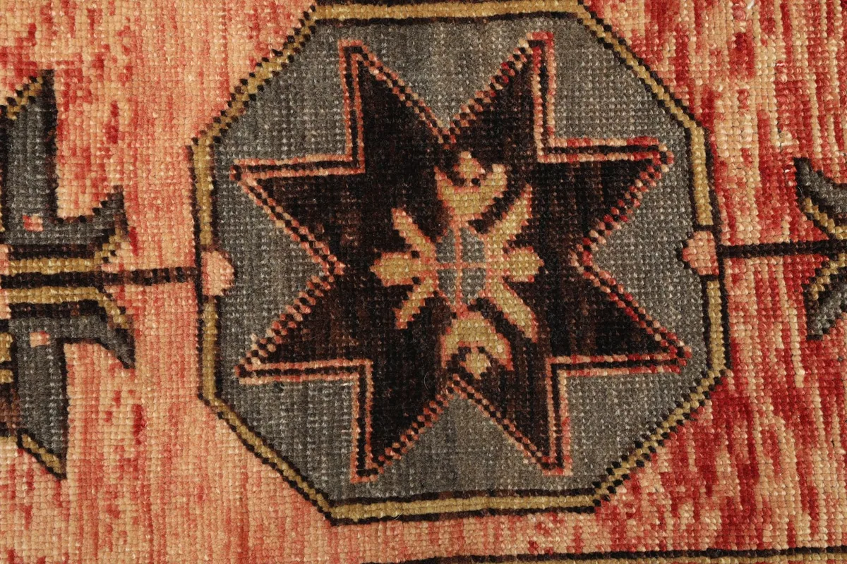 Detailed view of the intricate geometric pattern and texture of the vintage Anatolian rug.