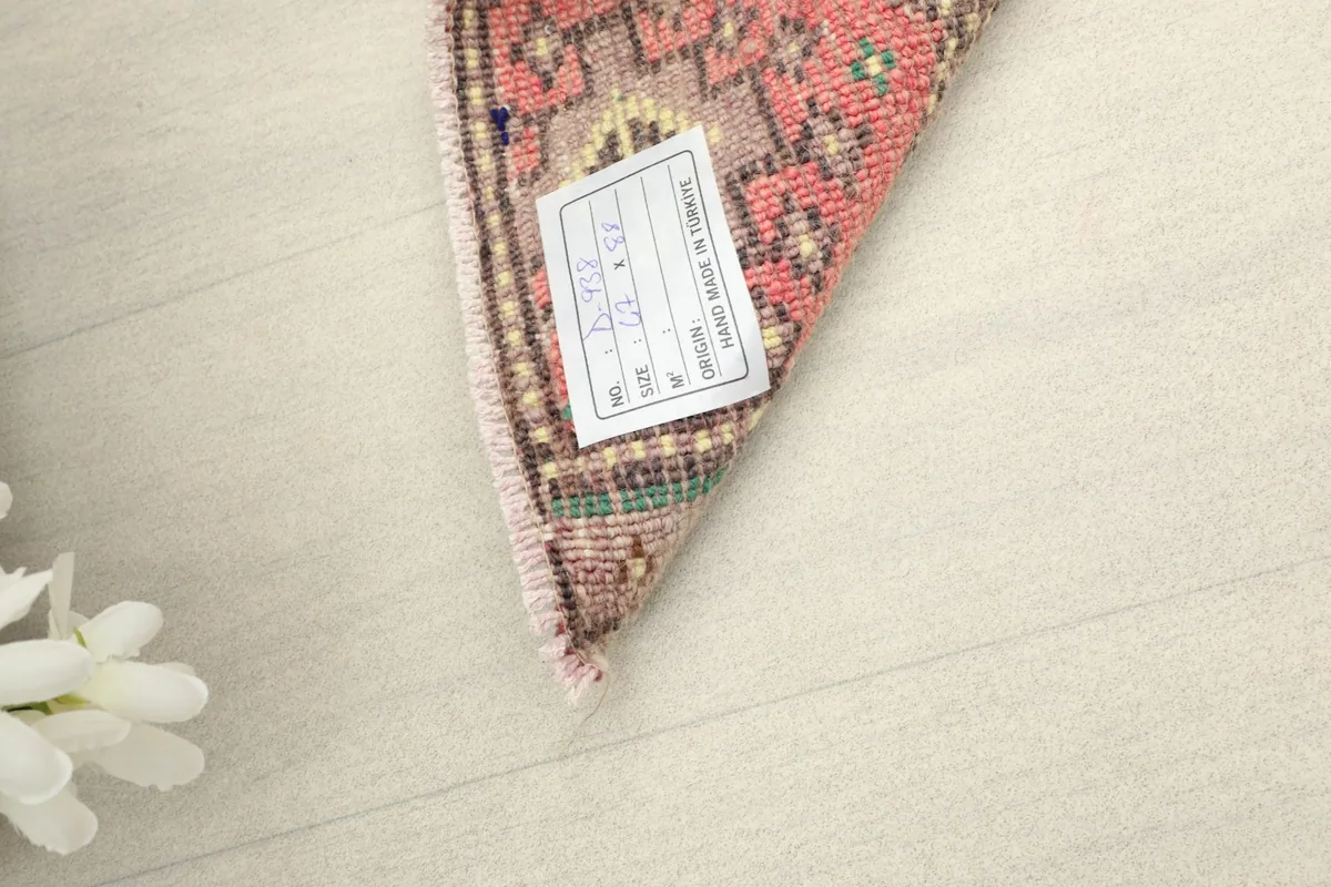 View of the rug's underside, revealing the tightly woven cotton foundation and hand-knotted wool pile.
