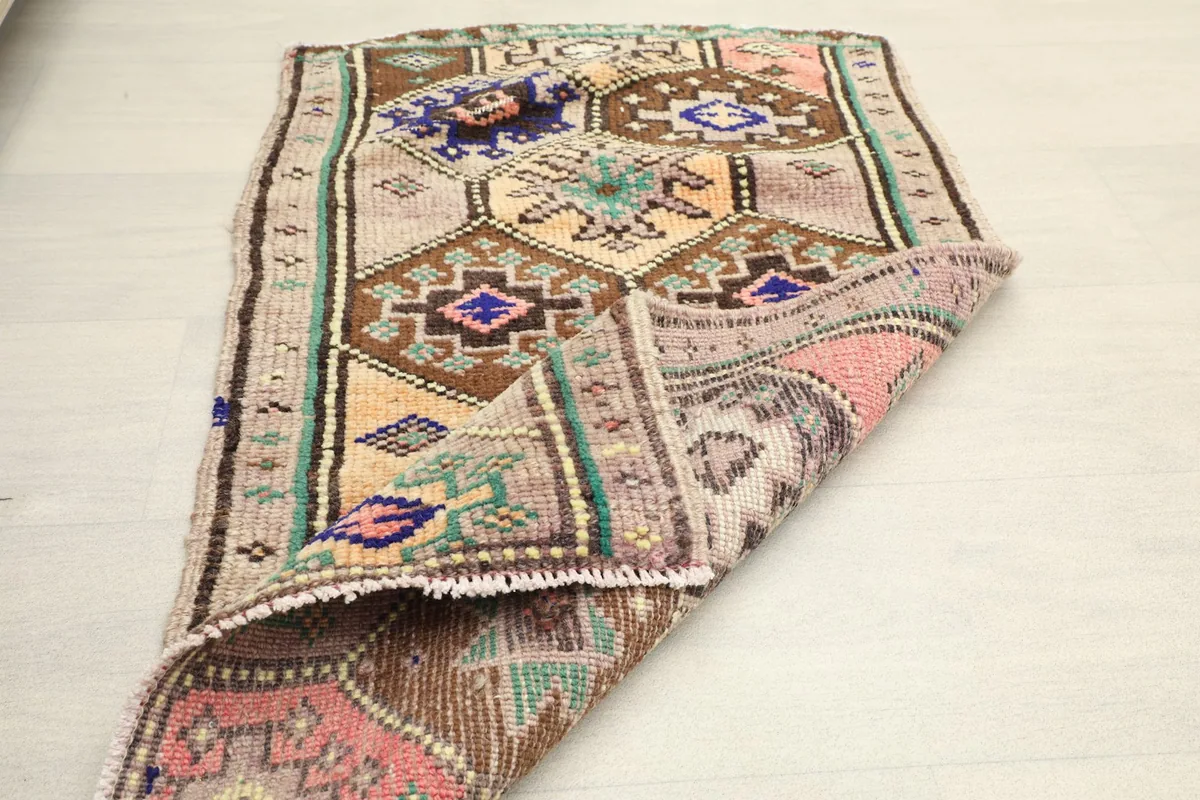 Partial fold of the rug, illustrating its flexibility and the overall design from a different perspective.