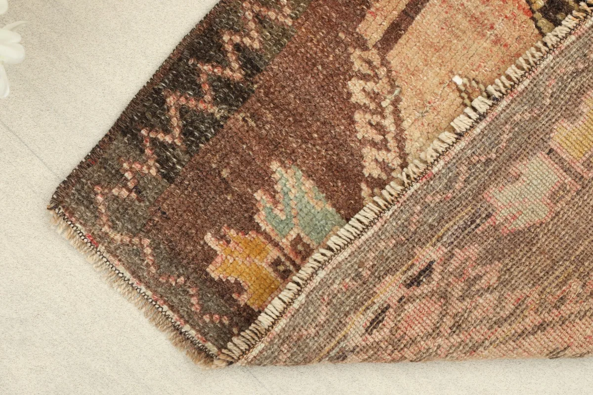 View showing the low wool pile texture and the hand-knotted construction of the rug.