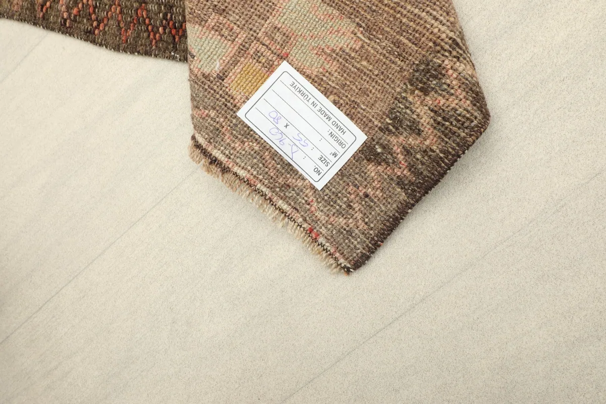 Underside of the rug, revealing the cotton foundation and a product label.