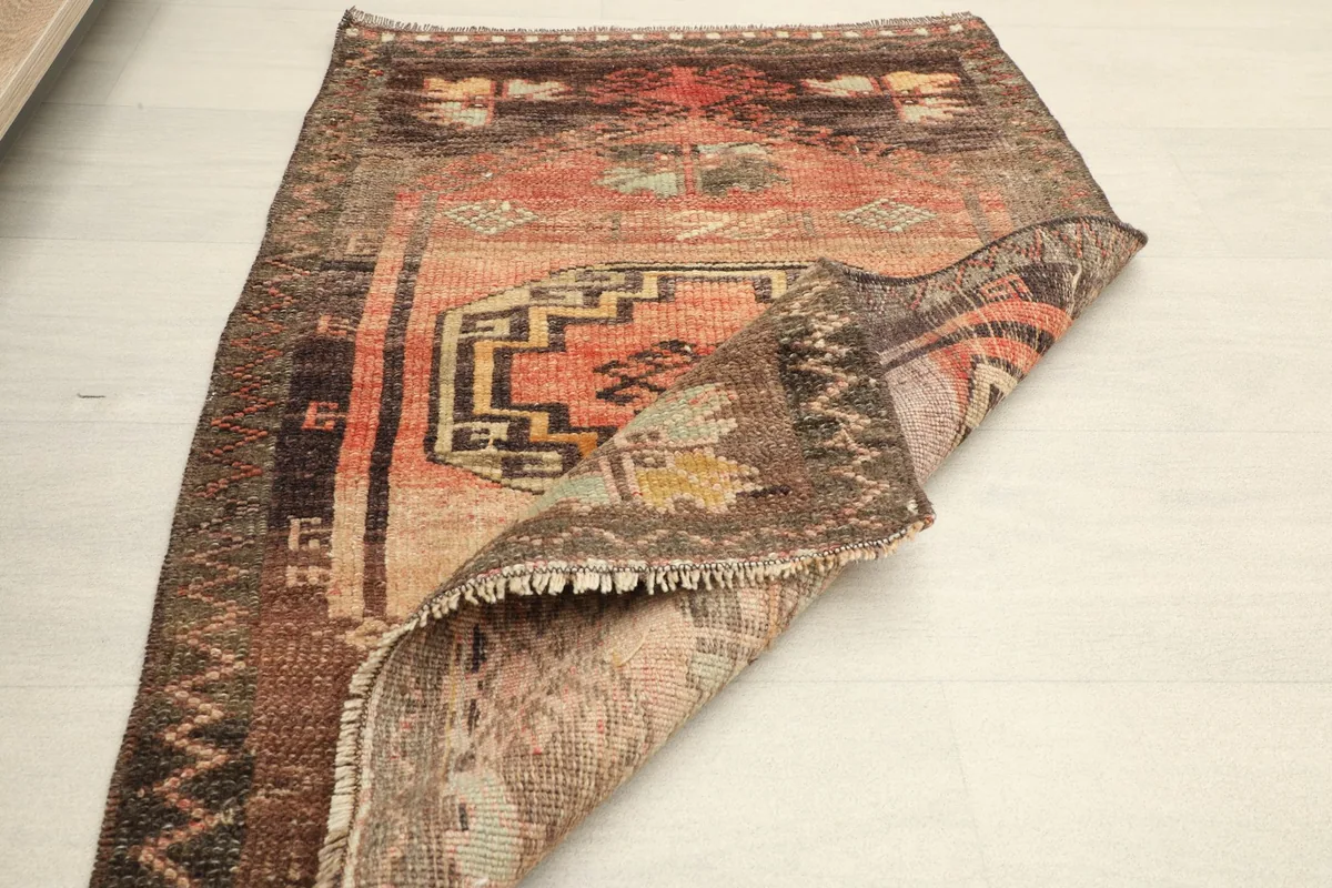 The rug folded to show its flexibility and the natural patina on both sides.