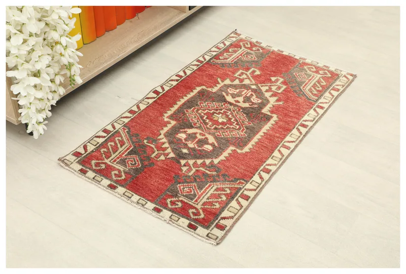 Full top view of the 2x3 red tribal Anatolian doormat rug on a light floor