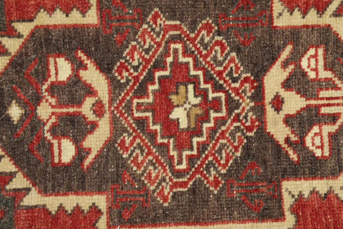 Close-up detail of the intricate tribal medallion design and colors in the rug's center
