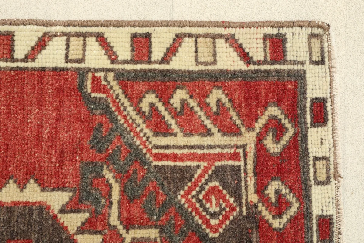 Close-up of a corner, revealing the hand-knotted texture and the low pile of the rug