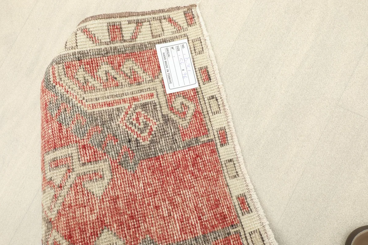 Underside of the rug, revealing the cotton foundation and hand-knotted construction