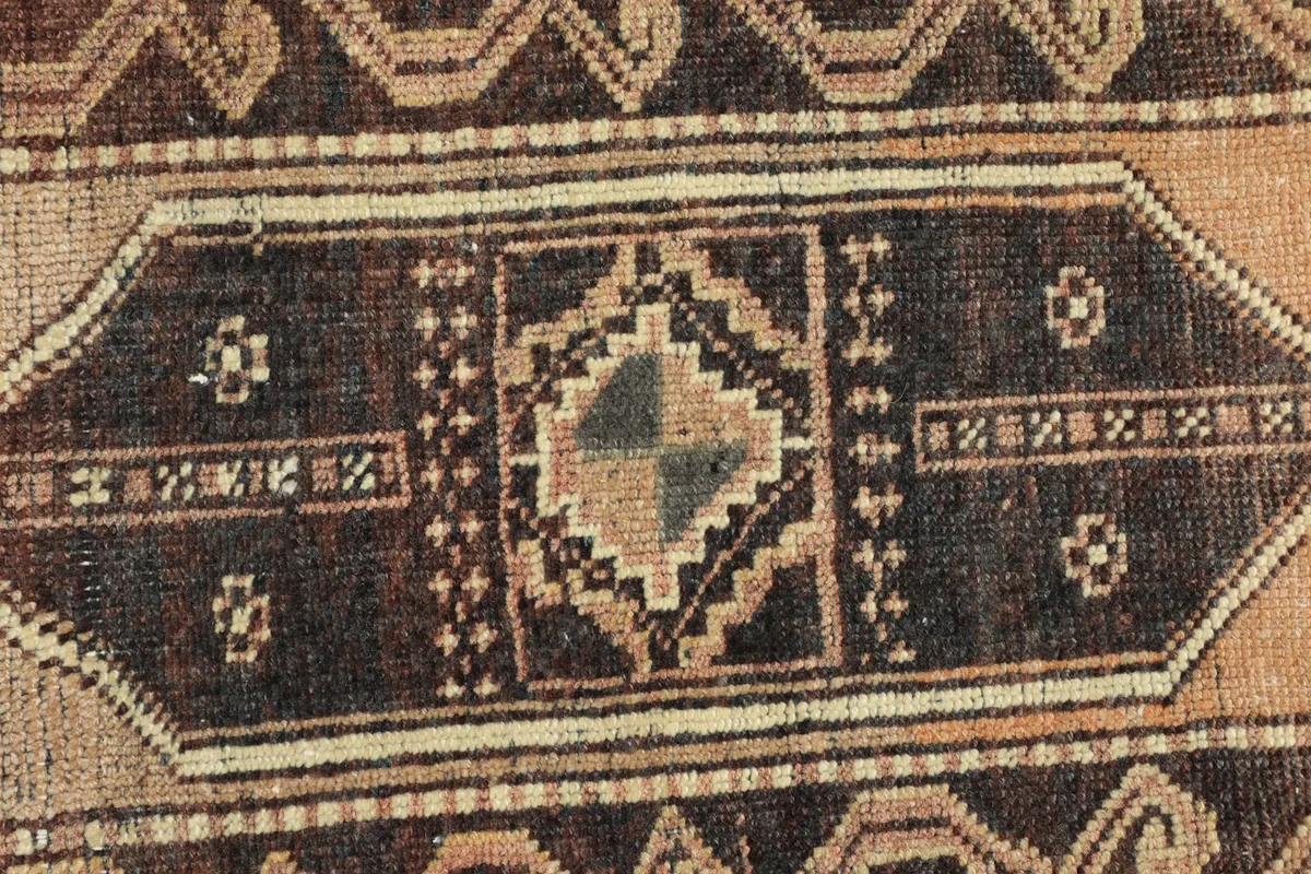 Close-up of the intricate geometric patterns and colors in the rug's central medallion.