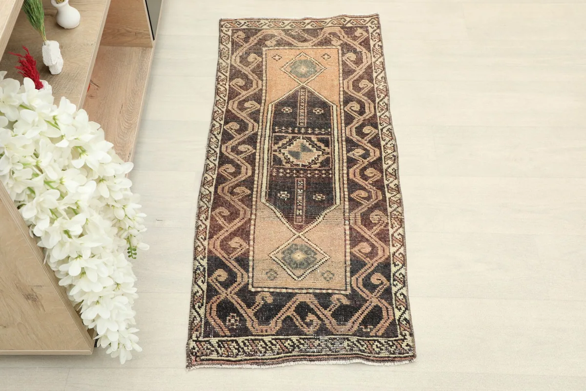 Top-down view of the brown and beige geometric doormat, highlighting its full pattern.