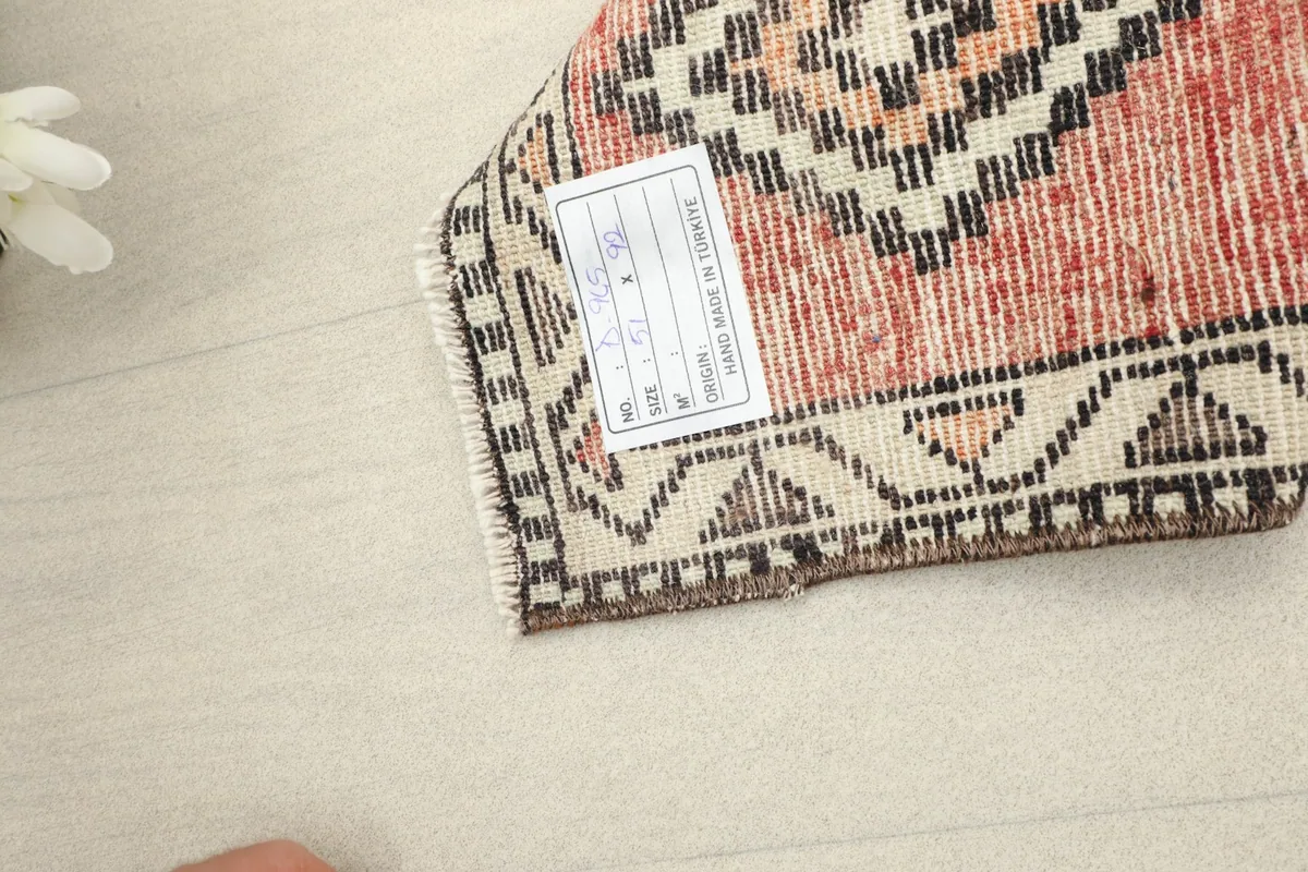 Close-up of the rug's reverse side, revealing the cotton foundation and hand-knotted construction.