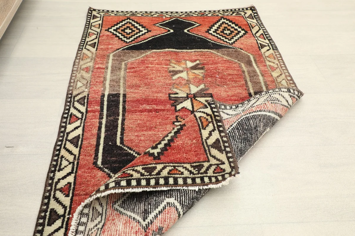 Another folded view of the rug, showing its flexibility and the back of the weave.