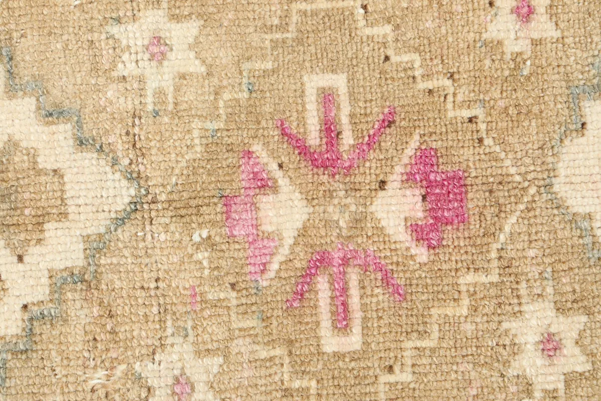Detailed close-up of the hand-knotted wool pile and tribal patterns, showing texture