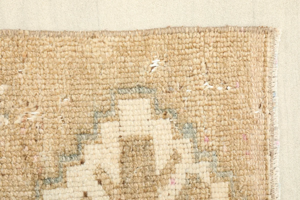 Close-up of the rug's edge, showing the tight knotting and a small section of the border