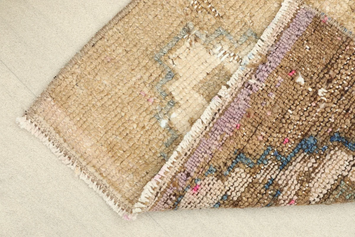View of the back of the rug, revealing the cotton foundation and hand-knotted construction