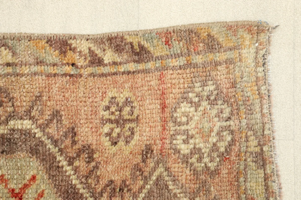 Side border detail, illustrating the construction and the worn patina of the rug's edge.