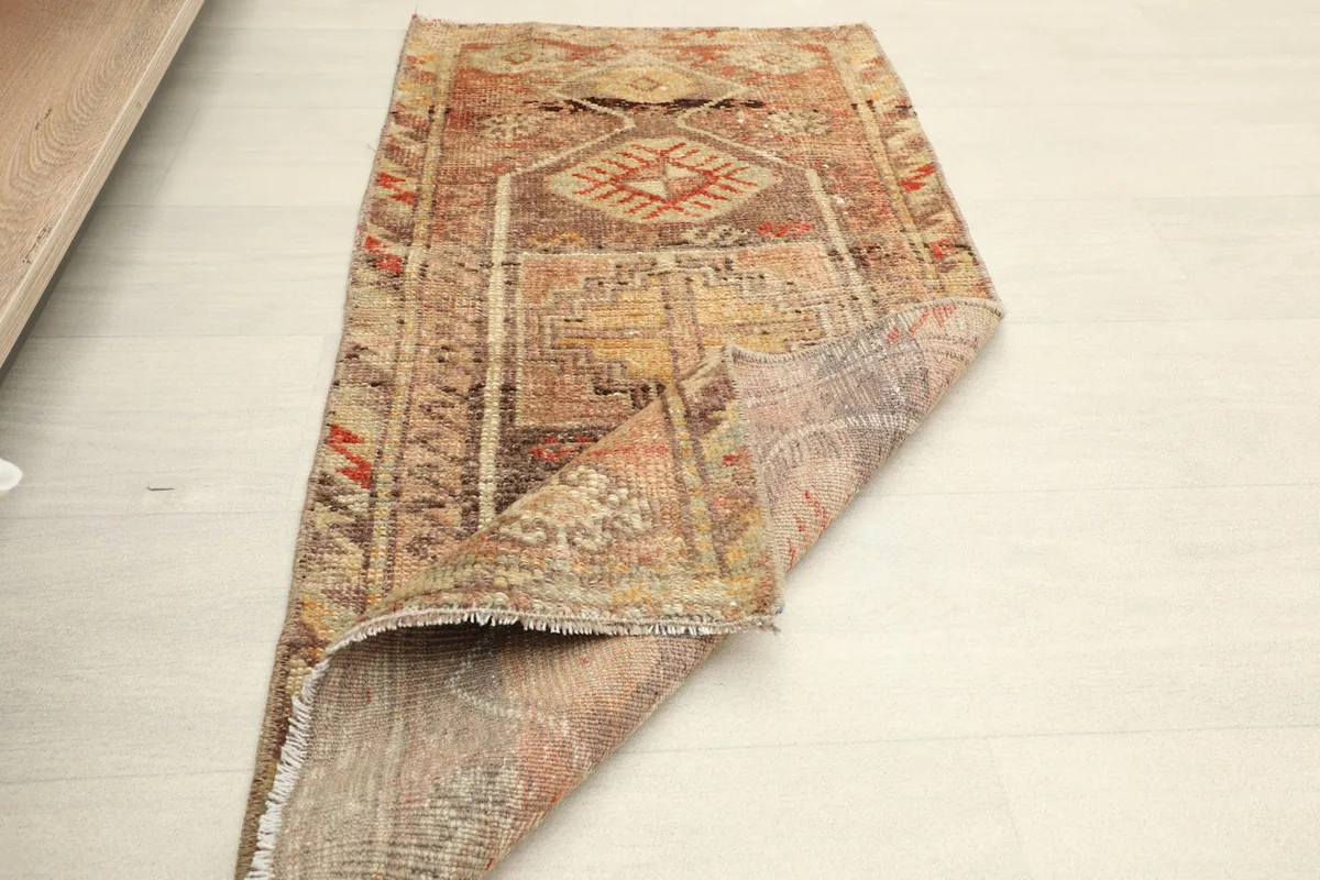 The rug folded to show its flexibility and the texture of both the front and back surfaces.