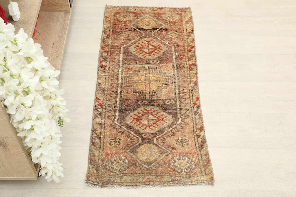Overhead view of the hand-knotted Anatolian rug, highlighting its rust, beige, and brown colors.