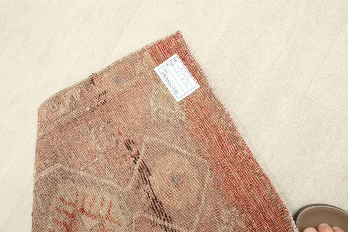 Overhead view of the rug with a label, indicating its size and origin.