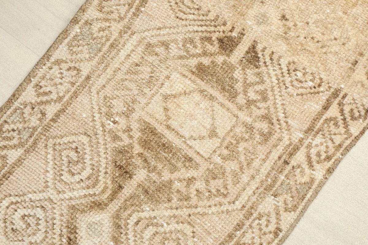 Close-up view of the central geometric patterns in tan and brown.