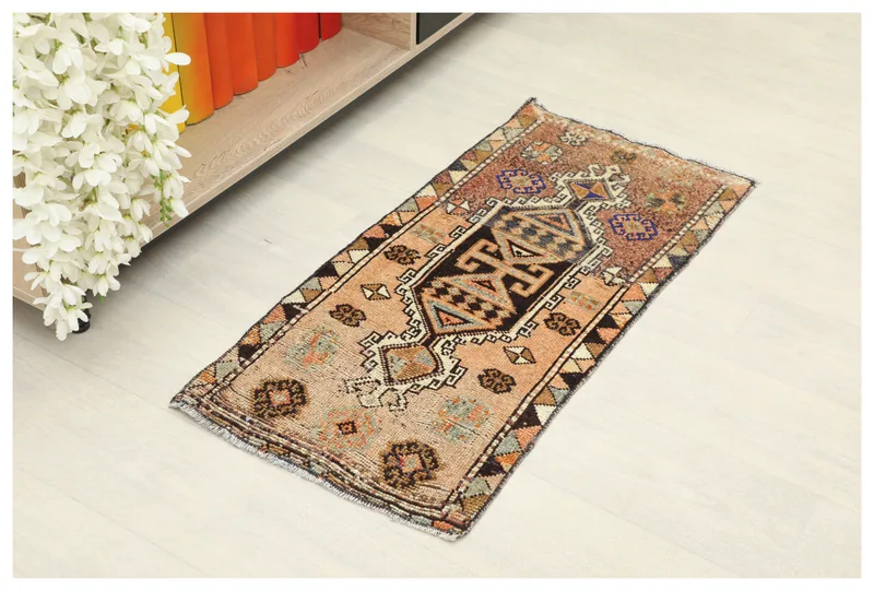 Full top view of the beige tribal geometric doormat on a white background