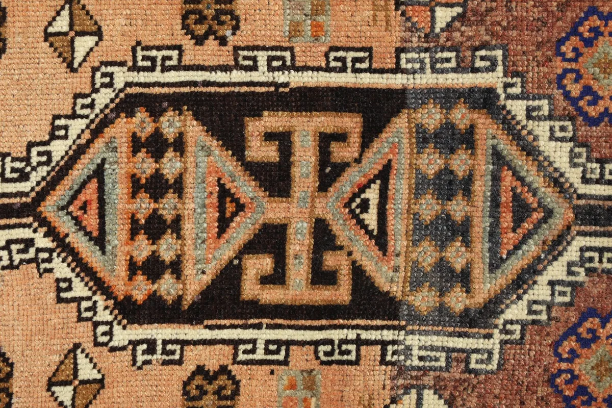 Detailed shot of the intricate tribal geometric pattern in the rug's center