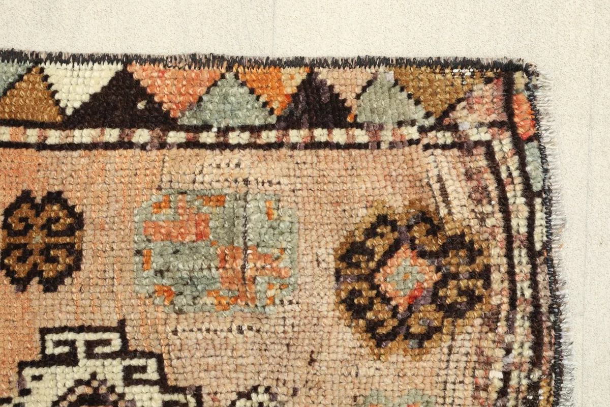Detail of the rug's border and field, revealing the texture and minor wear