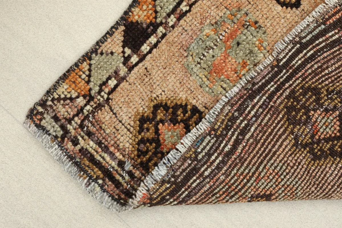 View of the rug's underside, showing the hand-knotted cotton foundation and wool knots