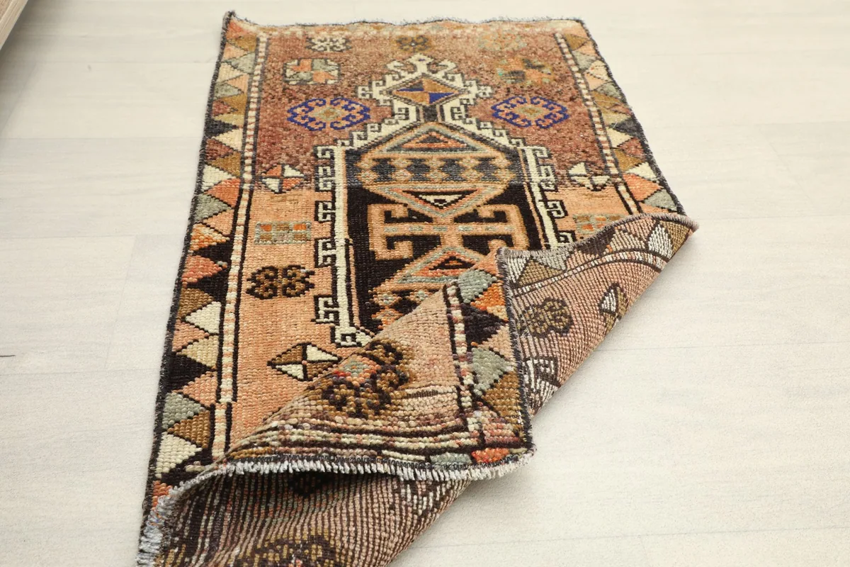 The rug partially folded, displaying both the pile side and the back of the weave